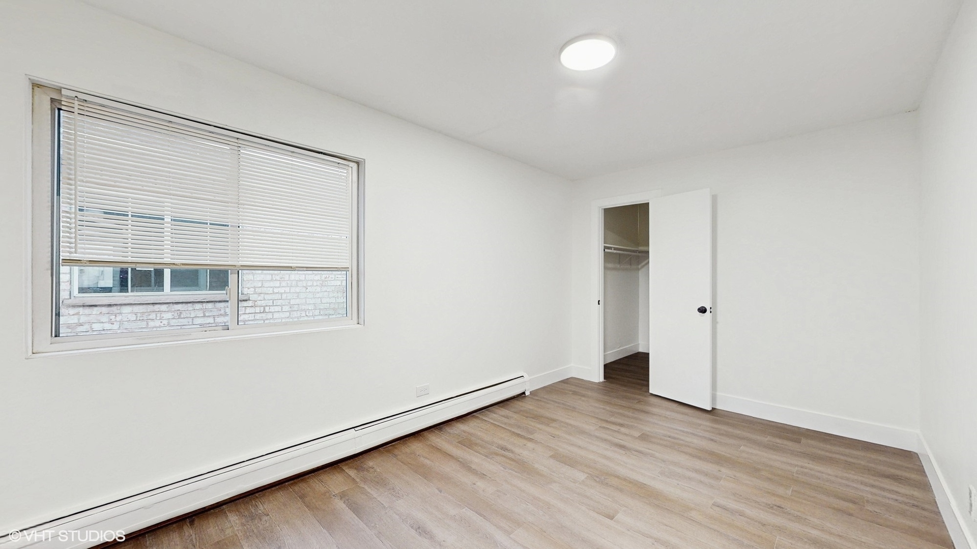 10410 Michael Todd Terrace, Unit 2E Glenview, IL 60025 - Photo 11 of 15 an empty room with wooden floor and windows