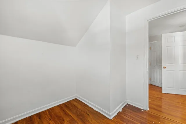 a view of a room with wooden floor
