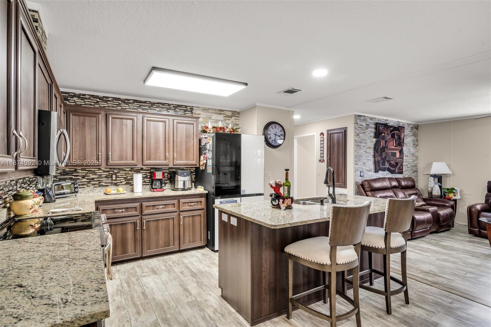 a kitchen with lots of counter top space and painting on the wall