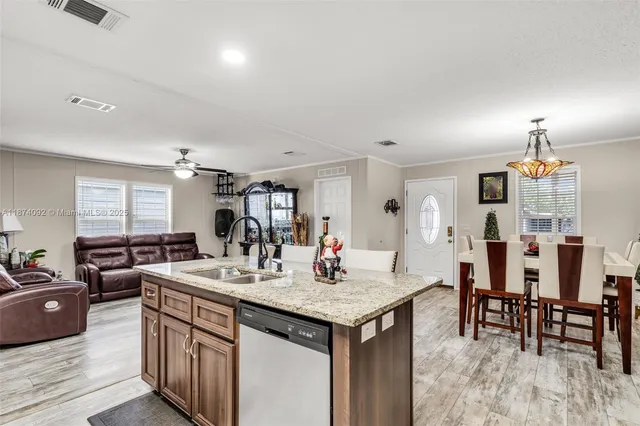 a kitchen with center island table and chairs