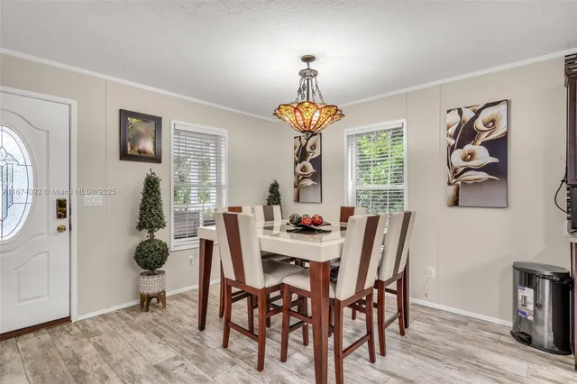 a view of a dining room with furniture wooden floor and a chandelier
