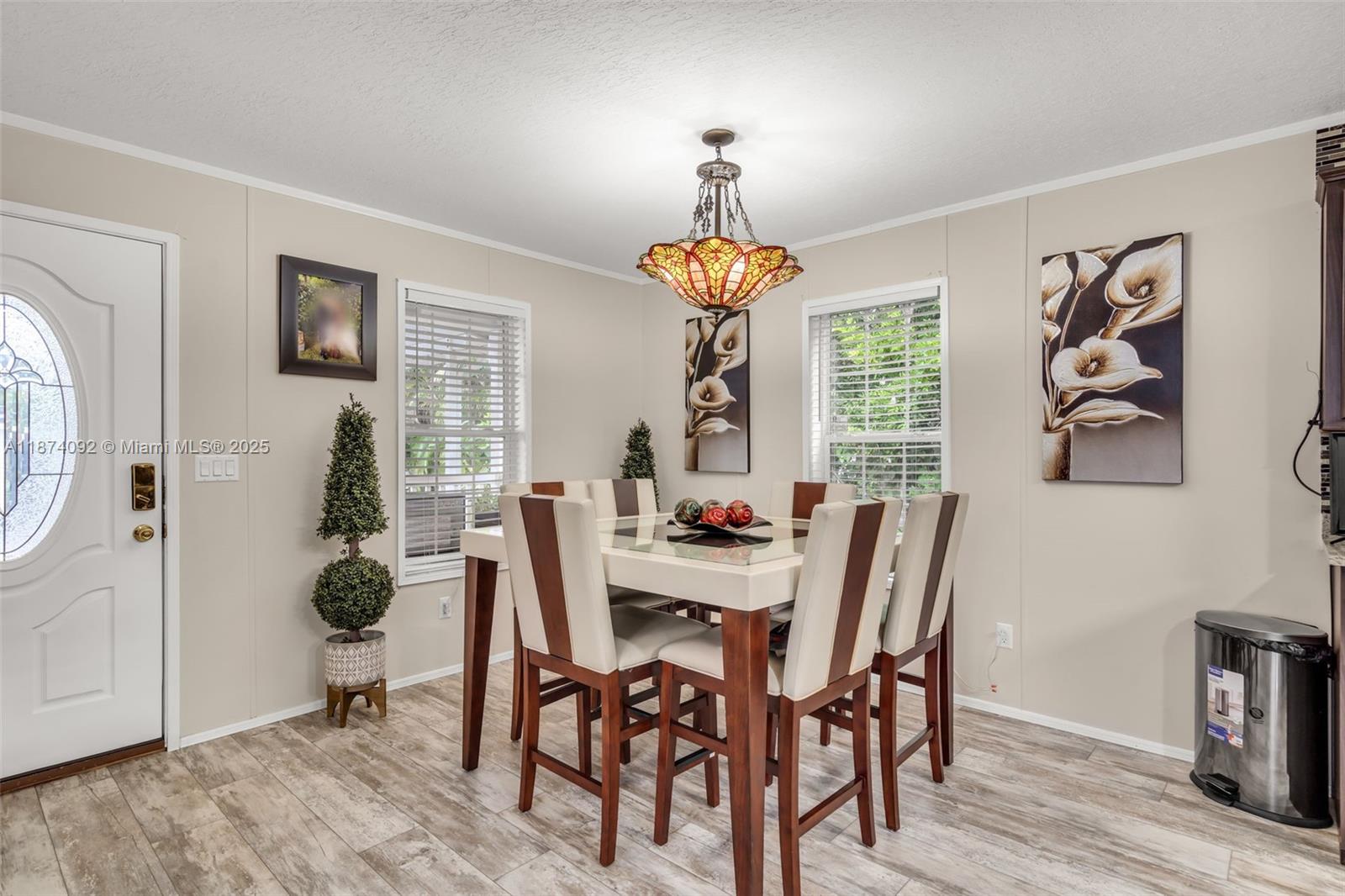 12850 West State Road, Unit 1 Davie, FL 33325 - Photo 12 of 32 a view of a dining room with furniture wooden floor and a chandelier