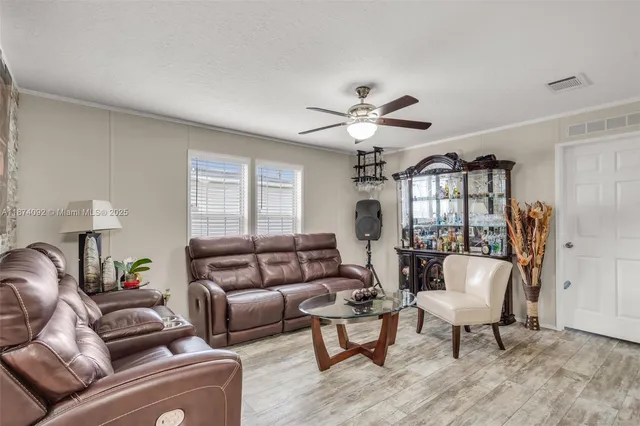 a living room with furniture a chandelier and a window