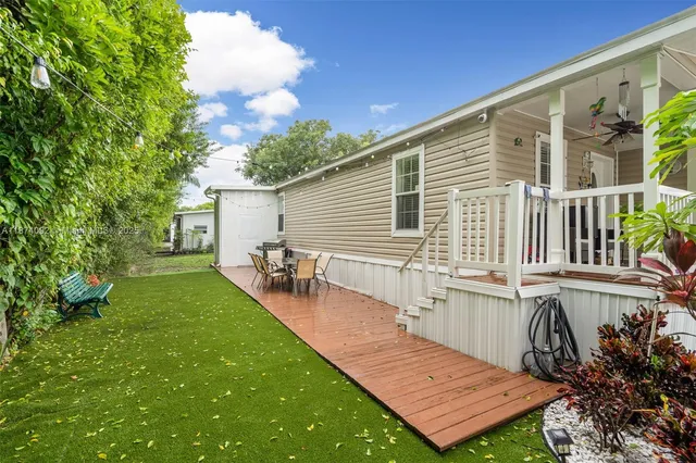 a view of a house with backyard and sitting area
