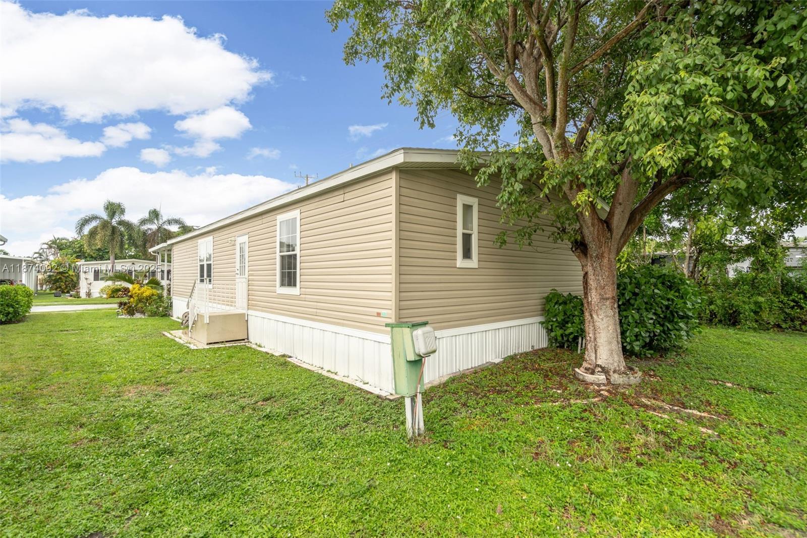 12850 West State Road, Unit 1 Davie, FL 33325 - Photo 19 of 32 a view of a house with a yard