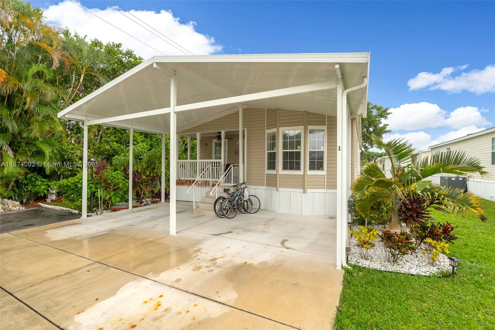12850 West State Road, Unit 1 Davie, FL 33325 - Photo 20 of 32 a view of a patio with table and chairs and potted plants