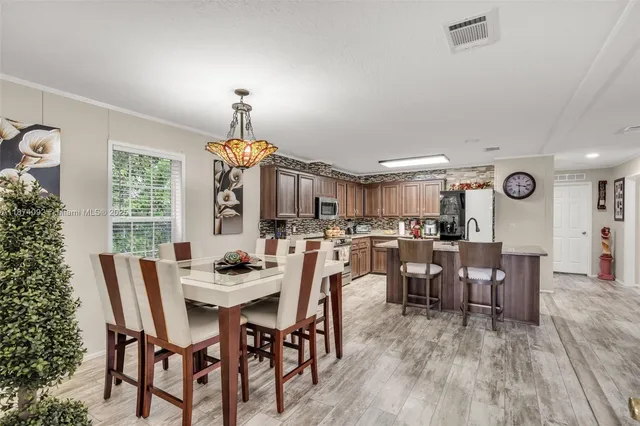 a dining room with furniture window and wooden floor