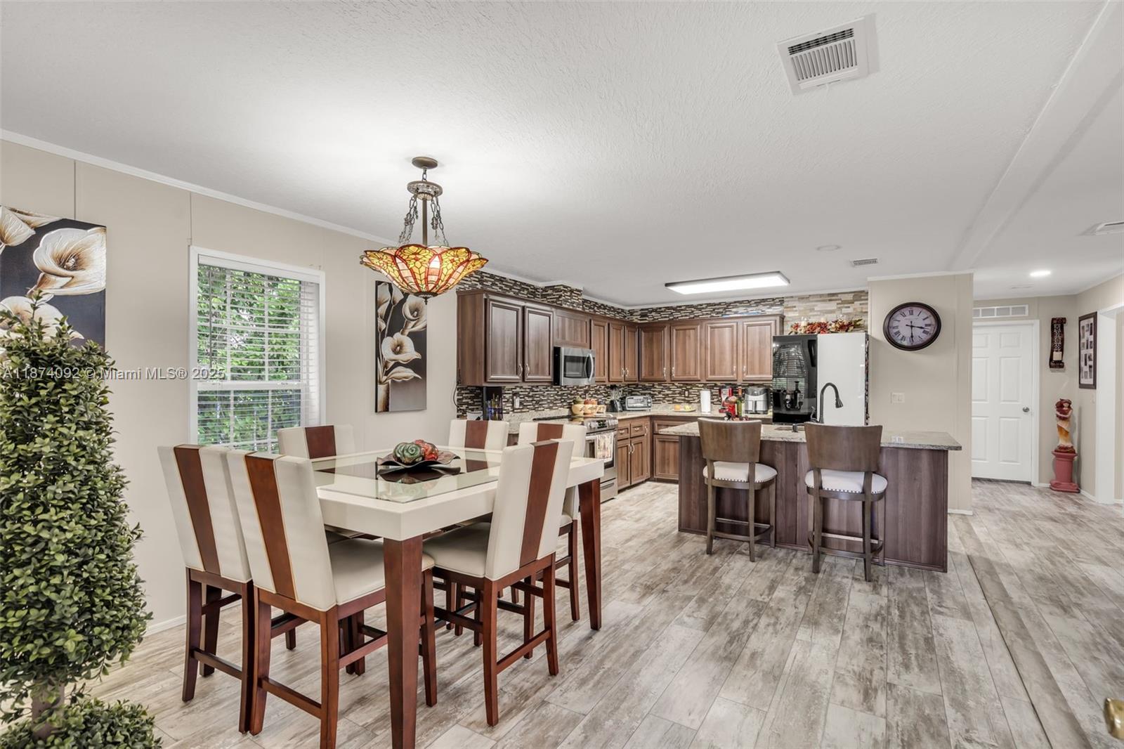 12850 West State Road, Unit 1 Davie, FL 33325 - Photo 2 of 32 a dining room with furniture window and wooden floor