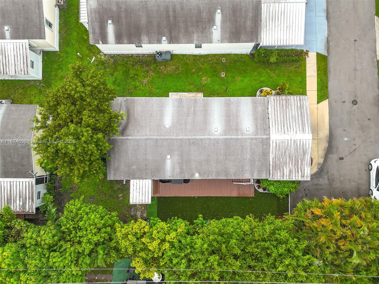 12850 West State Road, Unit 1 Davie, FL 33325 - Photo 21 of 32 an aerial view of a house with a garden and a yard