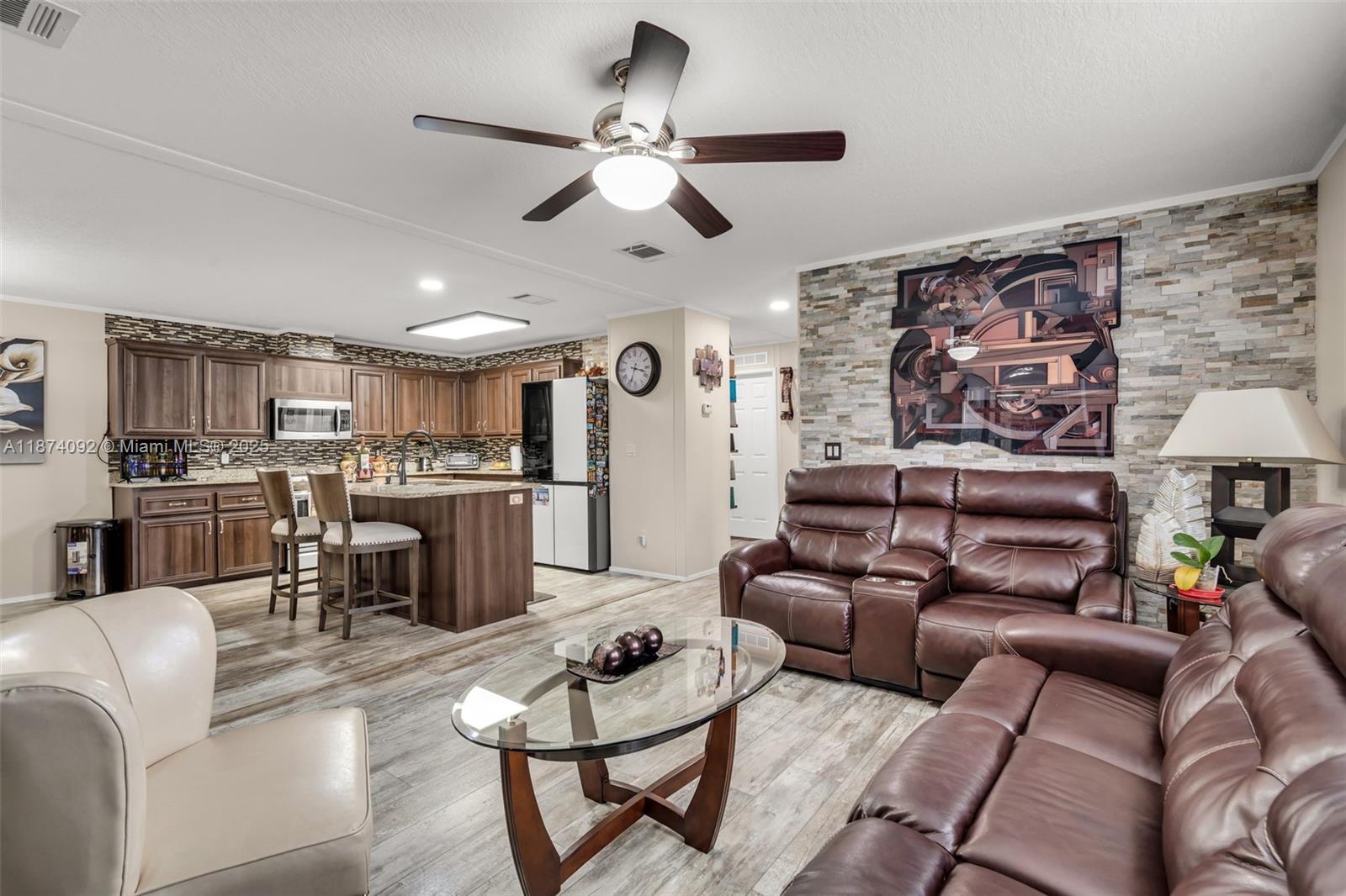 12850 West State Road, Unit 1 Davie, FL 33325 - Photo 3 of 32 a living room with furniture kitchen view and a chandelier