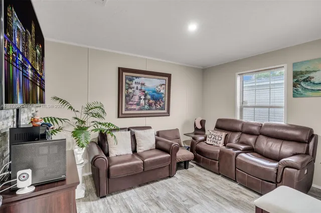 a living room with furniture or couch and a potted plant