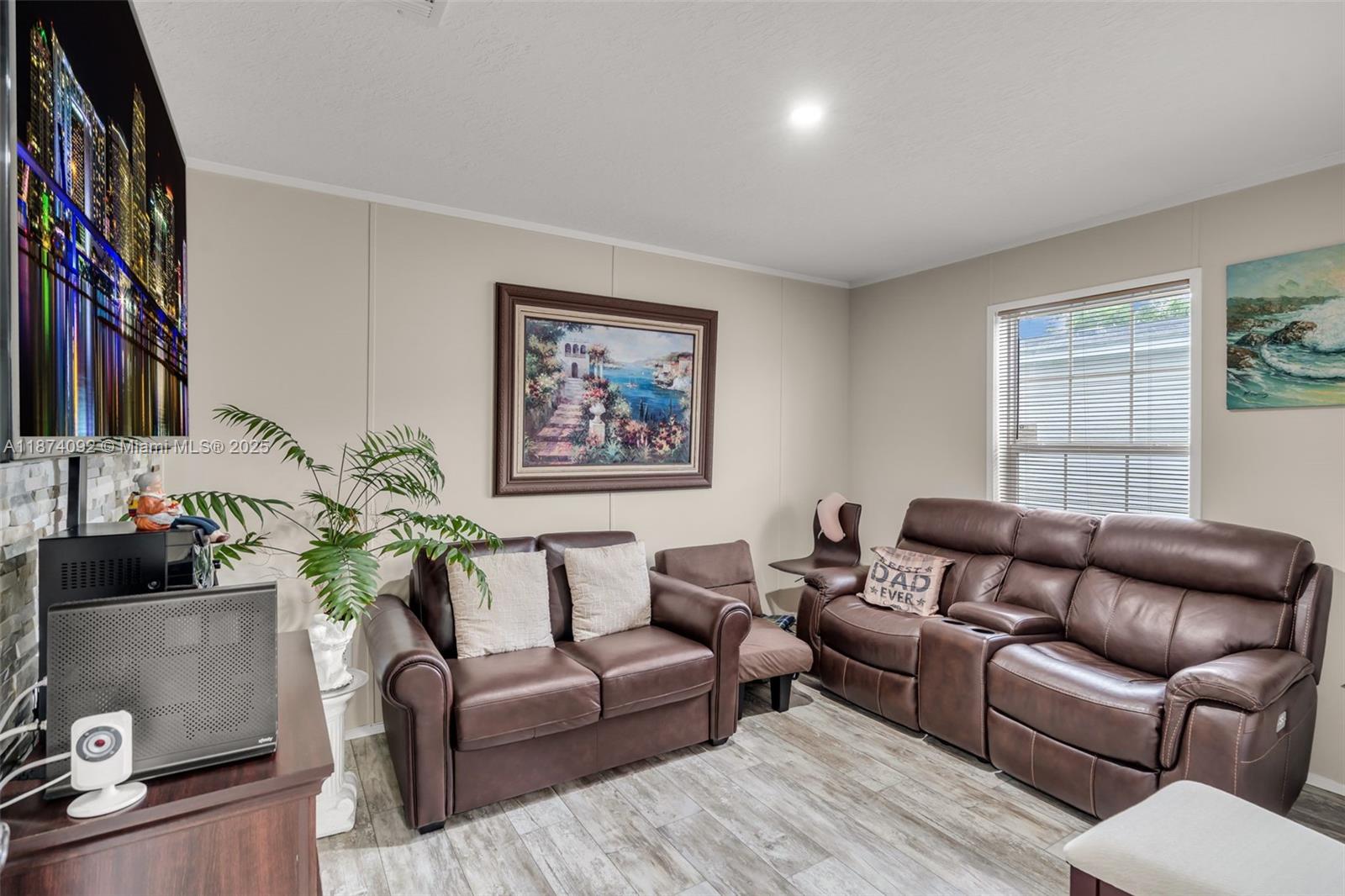 12850 West State Road, Unit 1 Davie, FL 33325 - Photo 4 of 32 a living room with furniture or couch and a potted plant