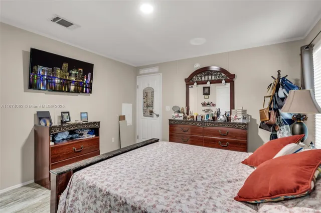 a bedroom with a bed and a dresser