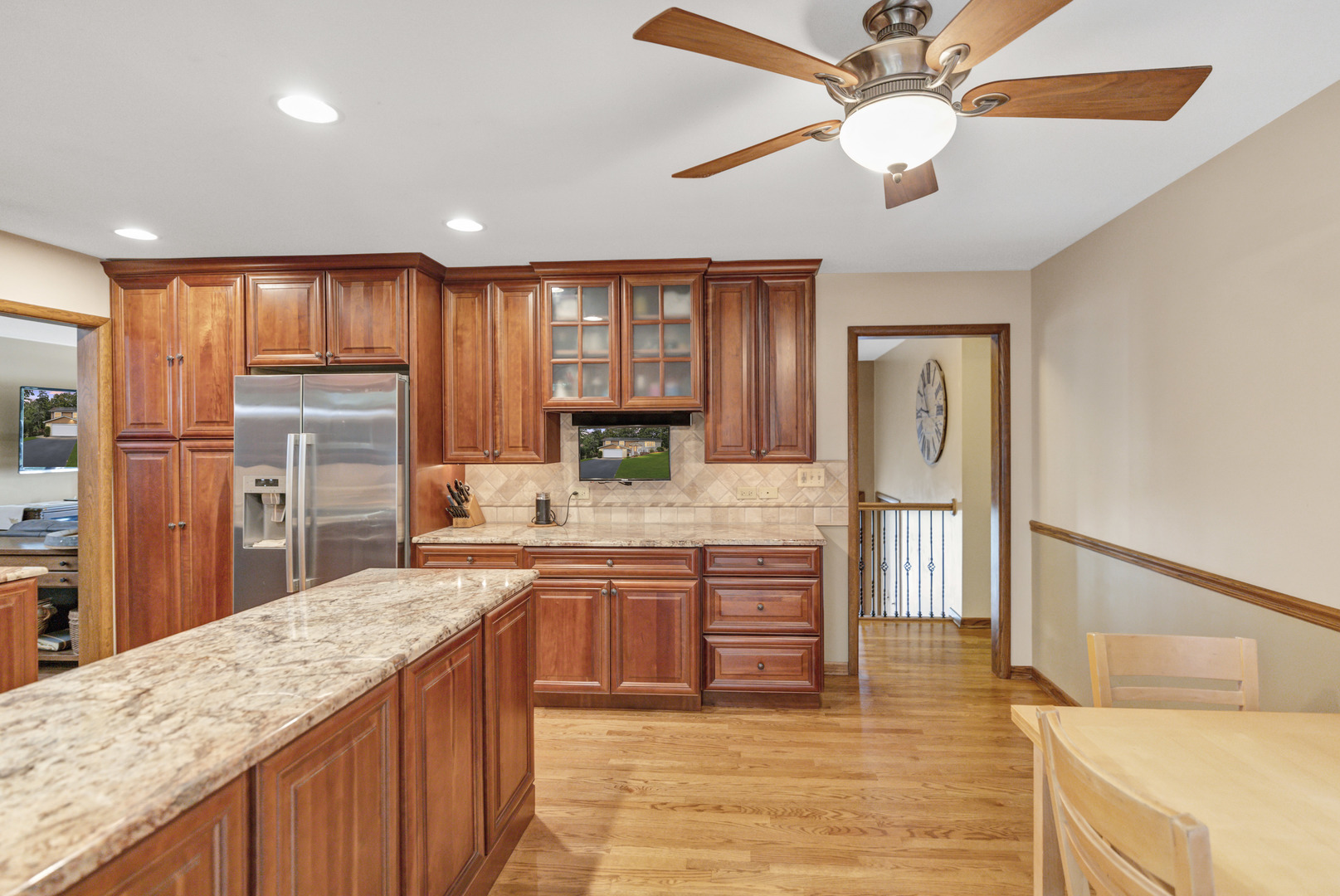512 Forest Drive Addison, IL 60101 - Photo 30 of 61 a kitchen with stainless steel appliances granite countertop a refrigerator a sink dishwasher a stove with wooden cabinets and floor
