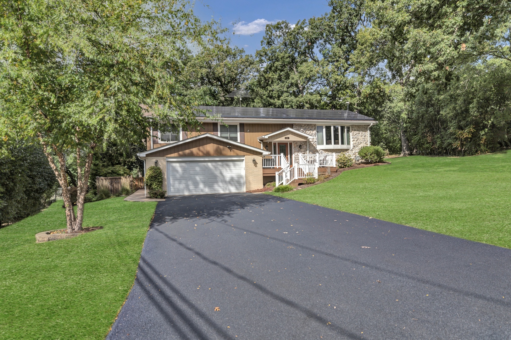 512 Forest Drive Addison, IL 60101 - Photo 3 of 61 a view of house with garden and tall trees