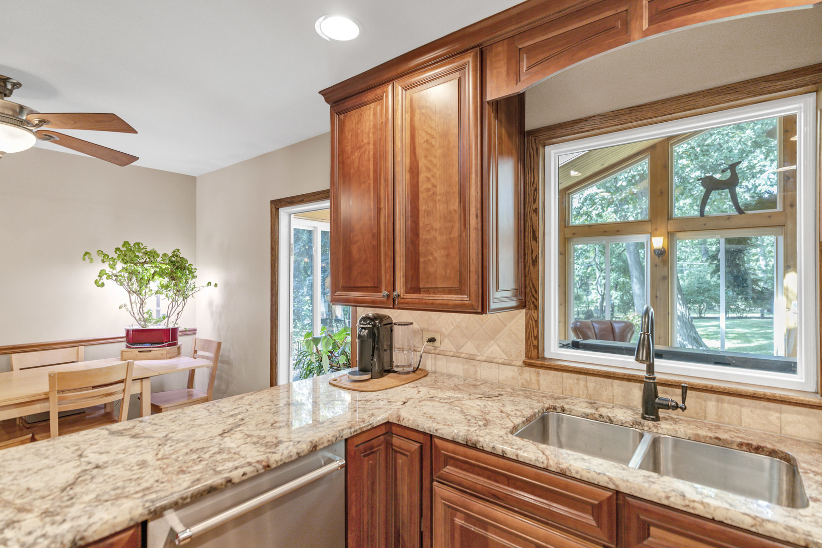 512 Forest Drive Addison, IL 60101 - Photo 33 of 61 a kitchen with granite countertop a sink a counter and a potted plant