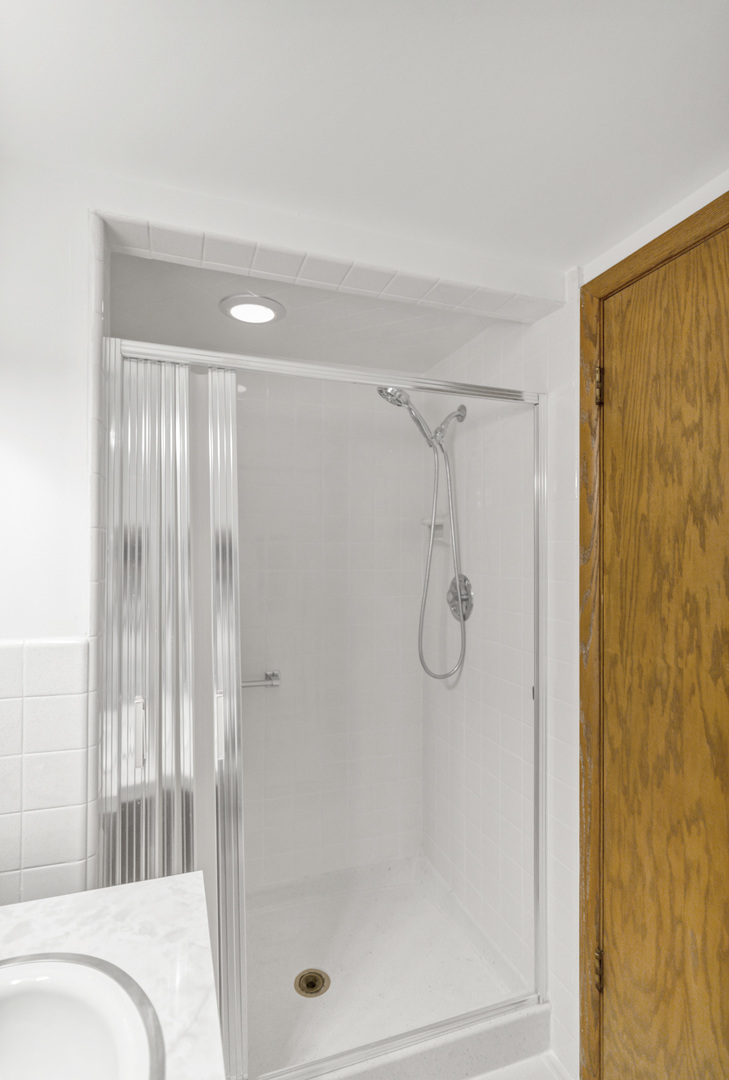 512 Forest Drive Addison, IL 60101 - Photo 53 of 61 a bathroom with a glass shower door