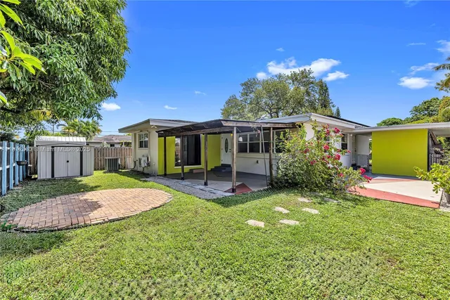 a view of a house with a yard porch and sitting area