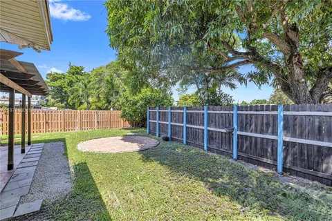 a view of a backyard with wooden fence