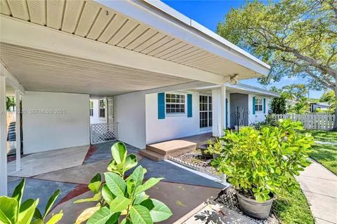 a front view of a house with outdoor seating