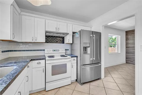 a kitchen with appliances cabinets and a counter top space