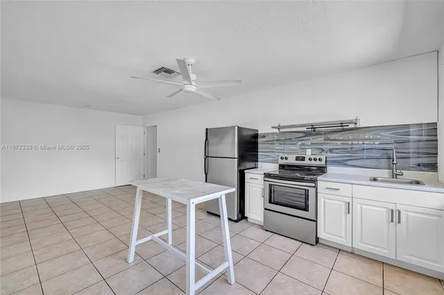a kitchen with cabinets and appliances