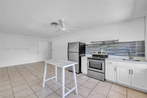 a kitchen with cabinets and appliances