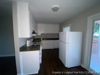 a kitchen with a refrigerator and a sink