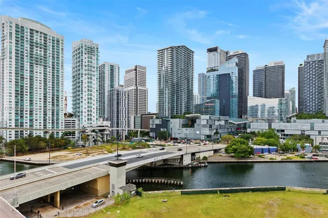 a living room with stainless steel appliances kitchen island a table and chairs