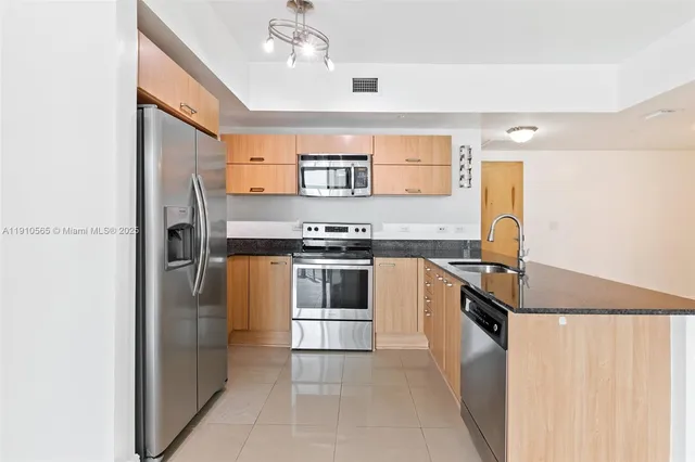 a kitchen with stainless steel appliances granite countertop a stove and a refrigerator