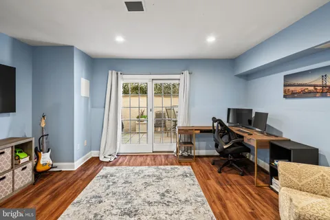 a view of a kitchen counter space a sink wooden floor and a window