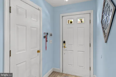 a view of entryway with furniture and wooden floor