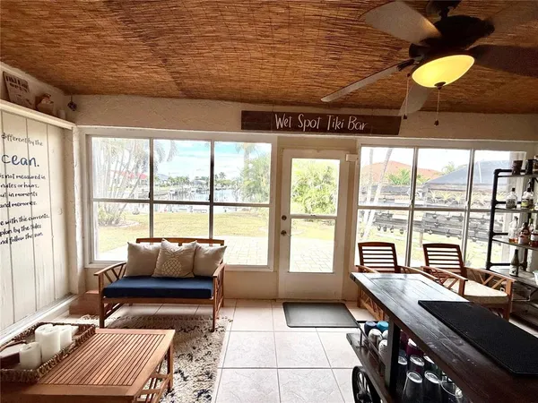 a livingroom with furniture and floor to ceiling window