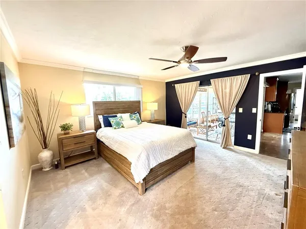 a spacious bedroom with a bed and a large window