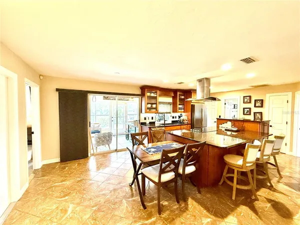 a view of a dining room with furniture and a kitchen