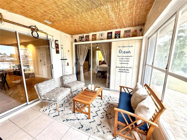 a bedroom with furniture and a large window