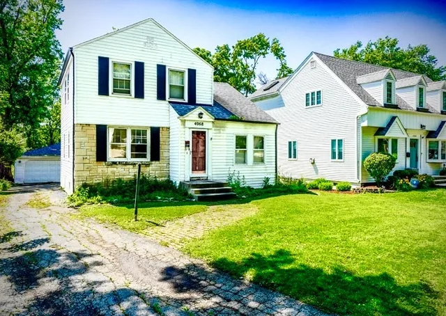 a front view of a house with garden and porch
