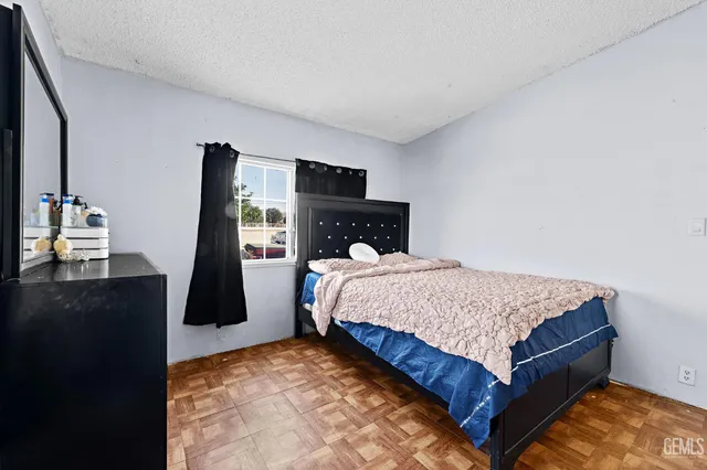 a bedroom with a bed and dresser