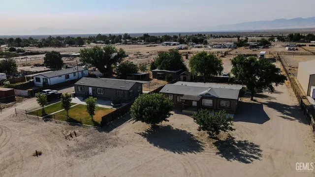 an aerial view of a house with yard basket ball court and outdoor seating