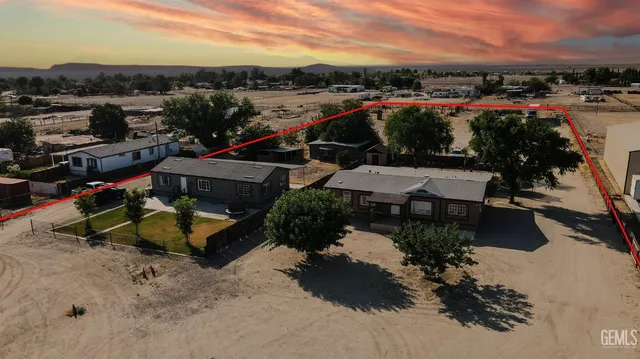 an aerial view of a house with a yard basket ball court and outdoor seating