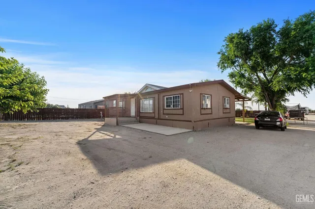 a view of house with outdoor space and car parked