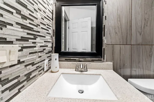 a bathroom with a tub sink and mirror