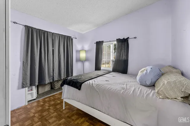 a bedroom with a bed and a large mirror