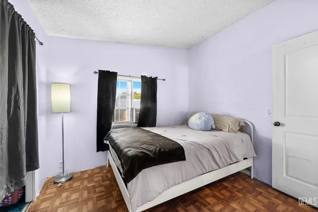 a bedroom with a bed and a mirror