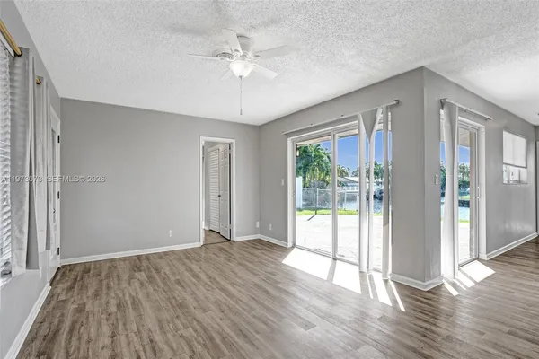 a kitchen with a table chairs a refrigerator and a stove top oven