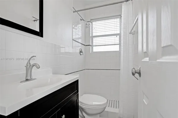 a bedroom with a bed and a flat tv screen