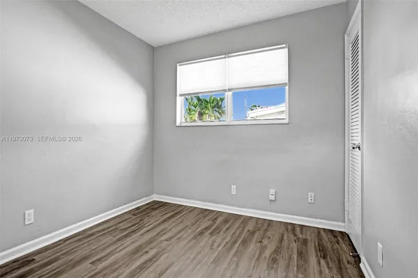 an empty room with wooden floor