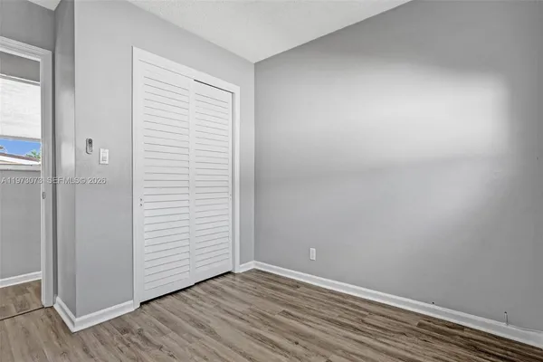an empty room with wooden floor