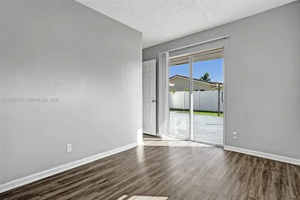 an empty room with wooden floor and closet
