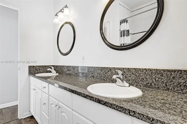 a view of a patio with table and chairs potted plants and a large tree